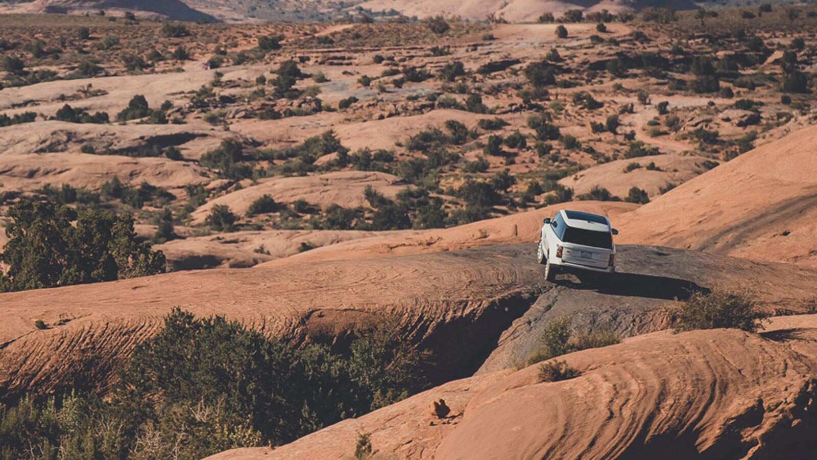 Range Rover driving on rocky terrain