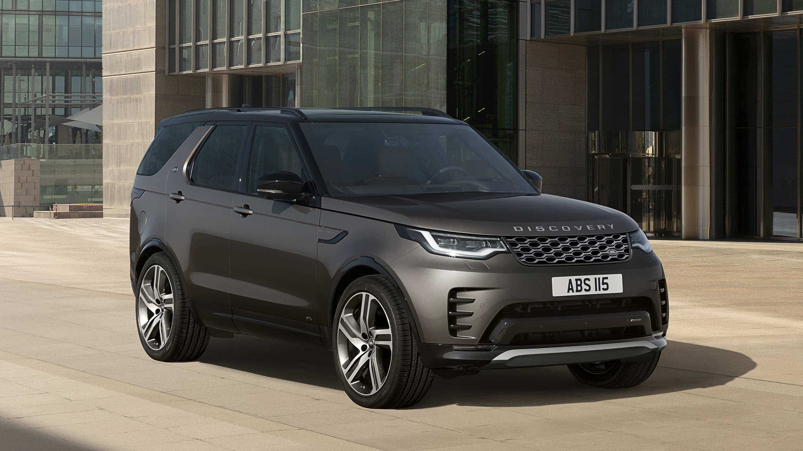 Discovery in Black Parked in front Glass Building