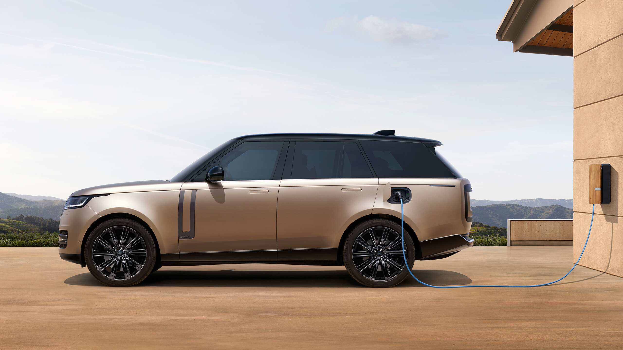 Parked Range Rover charging at the phev station point