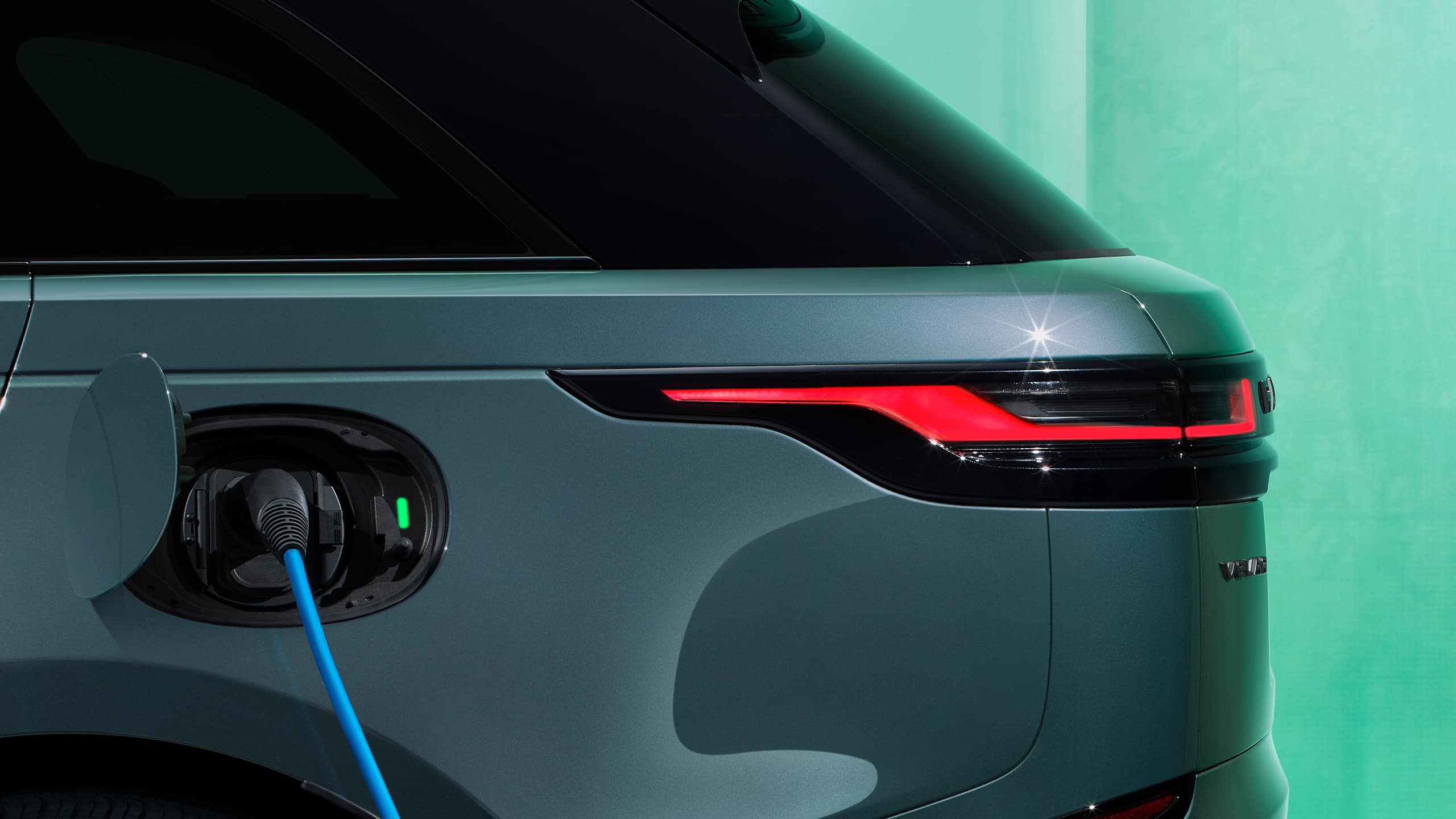 Range Rover Velar with its charging cable plugged in.