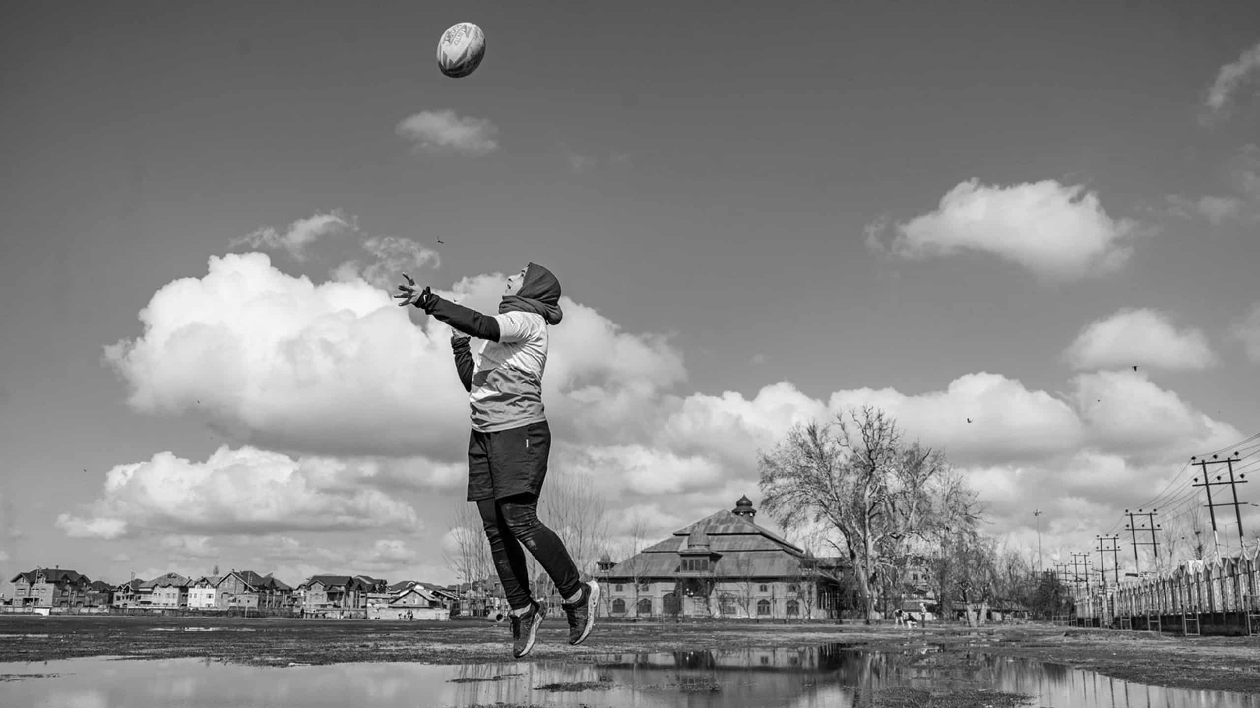 A lady throwing rugby ball